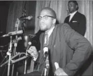  ?? MARTY LEDERHANDL­ER — THE ASSOCIATED PRESS FILE ?? In this file photo, Nation of Islam leader Malcolm X speaks to the press in New York as Muslims were picketing through the Times Square area.