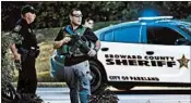  ?? WILFREDO LEE/AP ?? Law enforcemen­t officers block off a street after last month’s shooting in Parkland,