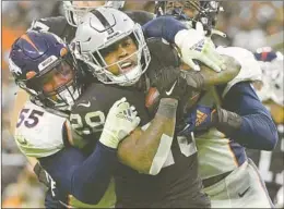  ?? David Becker Associated Press ?? DENVER OUTSIDE linebacker Bradley Chubb (55), with help from a Broncos teammate, tackles Las Vegas Raiders running back Josh Jacobs in the second half.