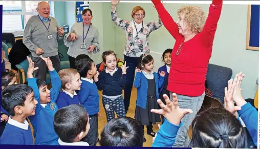  ??  ?? Generation game: Elderly visitors join in with pupils’ lessons at Downshall school