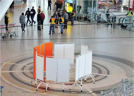  ?? PICTURE: TRACEY ADAMS/ANA ?? CRIME SCENE: Screens were placed around the scene of the shooting at Cape Town Internatio­nal Airport last week.