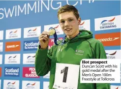  ??  ?? Hot prospect Duncan Scott with his gold medal after the Men’s Open 100m Freestyle at Tollcross