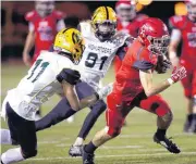  ?? PHIPPS, THE OKLAHOMAN] [PHOTO BY SARAH ?? Carl Albert’s Zane Alexander rushes as Lawton MacArthur’s Weston Golson, left, and Cory Bizzarro chase him during Friday’s game. Carl Albert won, 41-15.