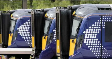  ?? Three ScotRail Class 385s stand at Eastfield. The Hitachi EMUs are entering traffic on the Edinburgh-Glasgow line following electrific­ation. A report by former rail minister Tom Harris rejects nationalis­ation. SCOTRAIL. ??