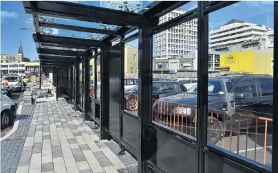  ?? PHOTO: GERARD O’BRIEN ?? Nearing completion . . . Glass shelters and new footpaths have been installed as constructi­on of Dunedin’s bus hub winds up.