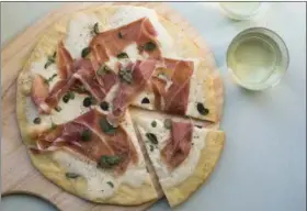  ?? SARAH CROWDER VIA AP ?? This February 2017 photo shows a burrata and prosciutto pizza in New York. This dish is from a recipe by Katie Workman.