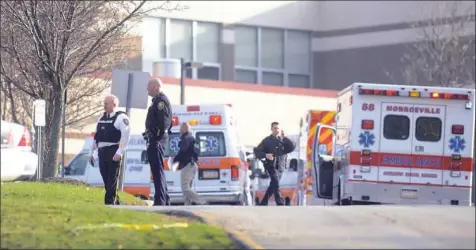  ?? Molly Born/Post-Gazette ?? Ambulances line up outside Franklin Regional High School in the immediate aftermath of the April 9, 2014, knife attack.