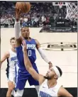  ?? MARK J. TERRILL — AP ?? The Clippers' Russell Westbrook, center, shoots over Orlando's Jalen Suggs during Tuesday night's game. The Clippers won, 118-102.