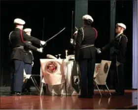  ?? RICHARD PAYERCHIN — THE MORNING JOURNAL ?? Lorain High School JROTC cadets pay tribute to service members missing in action as part of the school’s Veterans Day ceremony Nov. 7 at the school’s Performing Arts Center.