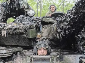  ?? EFREM LUKATSKY THE ASSOCIATED PRESS ?? Ukrainian tank operators ride toward their positions near Bakhmut, Donetsk region, Ukraine, Tuesday.