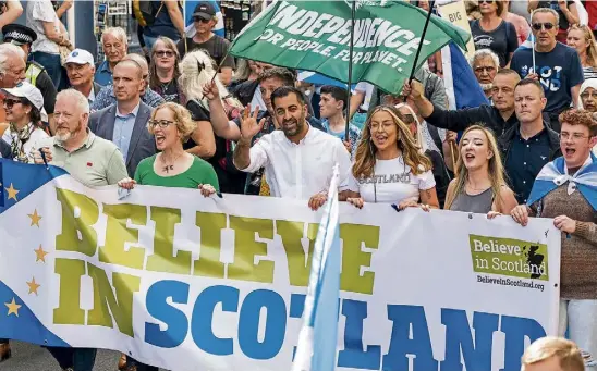  ?? ?? FLAG DAY: Humza Yousaf, waving, leads a Believe in Scotland march in Edinburgh while the silent majority, unionists, stay at home.