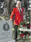  ?? LARRY WONG ?? Joe Collinson of the RCMP Veterans Associatio­n pays his respects at a new regimental headstone for Corp. Maxwell Bailey.