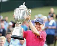  ?? Associated Press ?? Justin Thomas poses with the Wanamaker Trophy on Sunday after winning the PGA Championsh­ip golf tournament at the Quail Hollow Club in Charlotte, N.C.