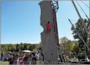  ??  ?? The rock climbing wall was a big hit with guests who came out to help raise awareness for childhood cancer Saturday at the Red Corner Benefit.