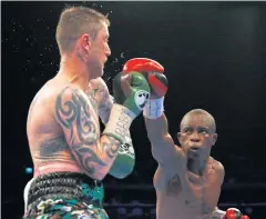  ?? REUTERS ?? Julius Indongo, right, throws a punch at Ricky Burns.