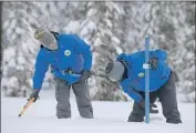  ?? Randall Benton Associated Press ?? ANTHONY BURDOCK, left, and Sean de Guzman of Water Resources measure snow near Echo Summit.