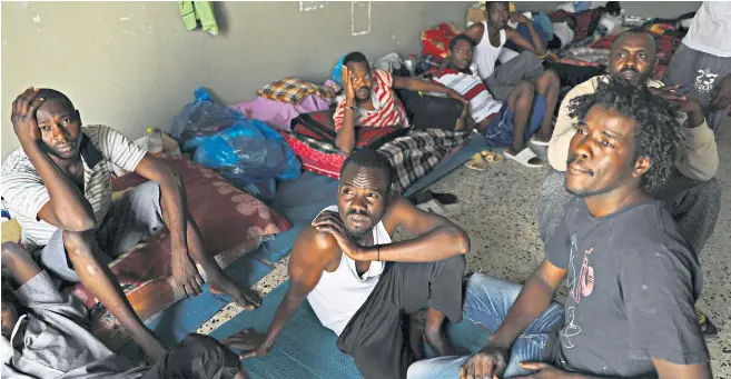  ??  ?? Migrants at an antiillega­l immigratio­n shelter in Tripoli. There is evidence some are being selected to fight in Libya’s civil war