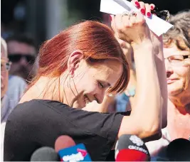  ?? PETER POWER / THE CANADIAN PRESS ?? Tim Bosma’s widow, Sharlene, celebrates outside court in Hamilton, Ont., following the guilty verdicts of Dellen Millard and Mark Smich on Friday.