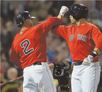  ?? STAFF PHOTO BY CHRISTOPHE­R EVANS ?? POSTSEASON BASH: J.D. Martinez (right) celebrates with Xander Bogaerts after his three-run home run in the first inning of last night’s Game 1 at Fenway.