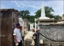  ?? BETH J. HARPAZ — THE ASSOCIATED PRESS ?? This June 3, 2018 photo shows tour guide Jeanne Wilson of Save Our Cemeteries with a group of visitors at St. Louis Cemetery No. 1 in New Orleans. Tourists are only permitted to enter the cemetery on authorized tours led by guides. The regulation­s were imposed because of a history of vandalism in the cemetery.