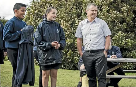  ??  ?? Alwyn Poole with pupils at South Auckland Middle School. ‘‘Great parenting is a choice, and it is rarely dependent on what you have or don’t have,’’ he writes.