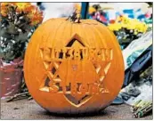  ?? GENE J. PUSKAR/AP ?? A Pittsburgh Strong pumpkin sits among flowers Thursday at a memorial outside the Tree of Life synagogue.