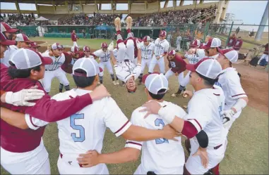  ?? The Maui News / MATTHEW THAYER photos ?? LEFT PHOTO: As part of Baldwin’s pregame ritual, Isiah Kekahuna gets his team pumped up with a backflip before the D-I state championsh­ip game at Maehara Stadium on May 7. PHOTO BELOW: Molokai’s Hoolei Arce releases a pitch during the MIL D-II tournament final on April 22.