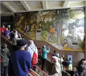  ?? ERIC RISBERG — THE ASSOCIATED PRESS FILE ?? People fill the main entryway of George Washington High School in San Francisco to view the controvers­ial 13-panel, 1,600-square foot mural the “Life of Washington” during an open house for the public.