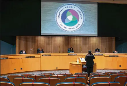  ?? REBECCA WRIGHT FOR THE AJC ?? Tiffany Porter, Gwinnett County’s new tax commission­er, speaks to the Board of Commission­ers in January. Porter makes $141,098, but a proposal to charge cities $2 a parcel in additional fees would raise her salary by $110,734, Lawrencevi­lle’s city manager says.