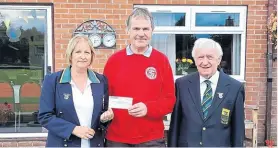  ?? PHOTO SUPPLIED ?? Chesterfie­ld Canal Trust secretary Rod Auton (centre) receives the cheque from captains Carol Norman and Chris Bromley at Retford Bowling Green.