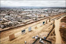  ?? JOSH HANER / THE NEW YORK TIMES 2017 ?? Eight border wall prototypes stand last year in front of the existing wall on the U.S.Mexico border in Otay Mesa, Calif. The Trump administra­tion wants new authority to acquire land in the area to more quickly build barriers.