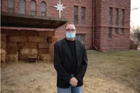  ??  ?? The Rev. Tim Thies poses in front of the empty Nativity stable at Canton Lutheran Church in Canton, South Dakota on Dec. 8, 2020. The church decided to cancel a live Nativity performanc­e this year after fears a large gathering could lead to more coronaviru­s deaths in the community. (AP Photo/Stephen Groves)