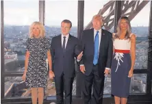  ?? YVES HERMAN/ASSOCIATED PRESS ?? Emmanuel Macron, second from right, and his wife Brigitte take U.S. President Donald Trump and first lady Melania Trump to dinner at the Jules Verne restaurant in Paris Thursday.