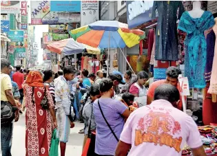  ??  ?? Shoppers say the rising cost of living and political instabilit­y have made them cautious about how they spend their money. Pix by M.D. Nissanka