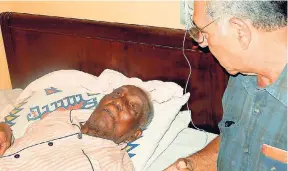  ?? PHOTO BY CECELIA CAMPBELL-LIVINGSTON ?? Custos of Clarendon William Shagoury visits centenaria­n Howell Burke at his house in Rock River, Clarendon, on the eve of his 107th birthday.