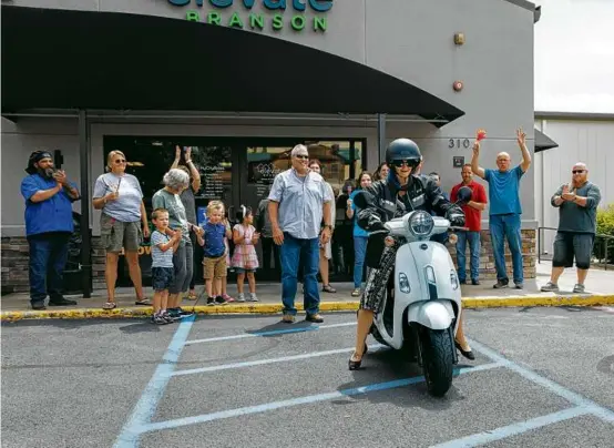  ?? CHASE CASTOR/NEW YORK TIMES ?? Tiffany Allen rode her new scooter amid cheers from people with Elevate Branson earlier this month in Branson, Mo.