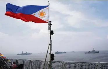  ?? REUTERS ?? MORE INDEPENDEN­T COURSE A Philippine flag flutters on the strategic sealift vessel, BRP Tarlac, during the commission­ing ceremony of the new ship and three landing craft heavies on Wednesday.