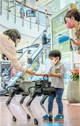  ?? ANTONOV/AFP Picture: MLADEN ?? FRIEND IN NEED: A 5G K9 robot distribute­s hand-sanitiser to visitors in a shopping mall in Bangkok yesterday, as sectors of the economy reopen after restrictio­ns to halt the spread of the coronaviru­s