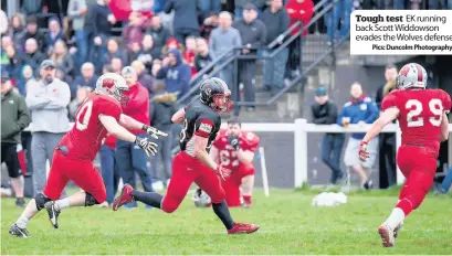  ?? ?? Tough test EK running back Scott Widdowson evades the Wolves defense