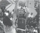  ?? CLAYTON FREEMAN/FLORIDA TIMES-UNION ?? Raines center Makai Purkiss (5) goes up for a shot as Paxon forward Ben Krause defends.