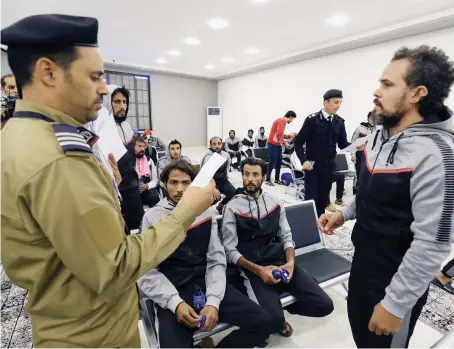  ?? File/AFP ?? Migrants from various nationalit­ies are gathered inside the building housing the Anti-Illegal Migration Agency in Tripoli, before being expelled to their countries of origin.