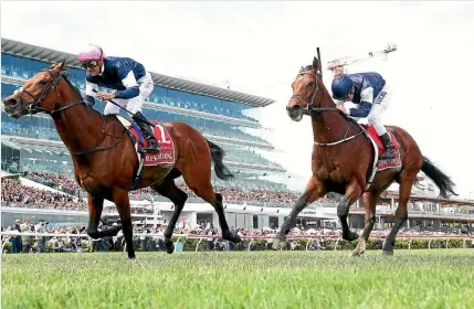  ?? PHOTOS: GETTY IMAGES ?? Corey Brown rides Rekindling, outside, to a narrow win over Johannes Vermeer in a thrilling finish to the Melbourne Cup yesterday.