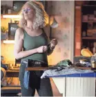  ?? RYAN GREEN ?? Laurie (Jamie Lee Curtis) gets her weapons in order waiting for Michael Myers in “Halloween.”