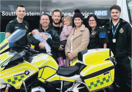  ??  ?? Mum and dad Leanne and Sam, pictured centre with daughter Imogen, meet the crew who helped them, from left Lloyd Easton, motorcycle paramedic Scott King (who was first on the scene) here holding baby Sebastian, Amy Johnson and Charlie Passmore who handled the emergency call