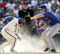  ?? MATT SLOCUM — THE ASSOCIATED PRESS ?? Philadelph­ia Phillies’ Freddy Galvis, left, scores past New York Mets starter Chris Flexen on a wild pitch during the fifth inning of a baseball game, Sunday in Philadelph­ia.