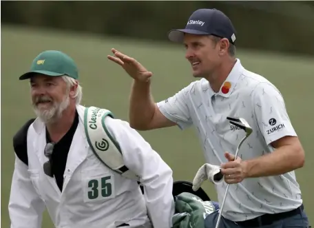  ?? Ap; BeLow, getty images ?? THORN IN THEIR SIDE: Justin Rose and his caddie David Clark react to his second shot on the 18th hole during the first round of the Masters at Augusta National Golf Club on Thursday in Augusta, Ga. Rose owns the early lead by four shots. Below, Bryson DeChambeau reacts to his putt on the 18th green.