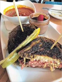  ??  ?? The Reuben sandwich and tomato soup. The Reuben — pastrami, sauerkraut, house-made Russian dressing, Gruyère on toasted rye with mustard and dill pickle — was an overall hit.