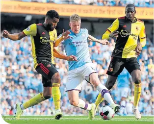  ??  ?? Manchester City’s Kevin De Bruyne breezes past two Watford defenders