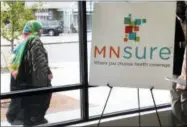  ?? THE ASSOCIATED PRESS ?? A woman walks past the Briva Health enrollment office for MNsure, Minnesota’s insurance marketplac­e, in Minneapoli­s. Health care consumers in most of the country are encounteri­ng a world of confusion and chaos as the open enrollment period to sign up...