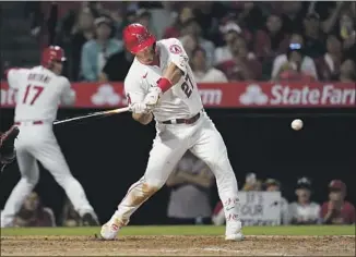  ?? Ashley Landis Associated Press ?? THE ANGELS’ Mike Trout doubles to center field to drive in a pair of runs during the fifth inning. Trout drove in Taylor Ward and David Fletcher to give the Angels a 3-0 lead over the Nationals.